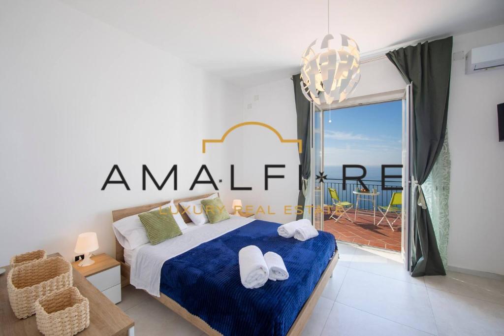 a bedroom with a bed and a balcony with a view at Casa Angelina in Conca dei Marini