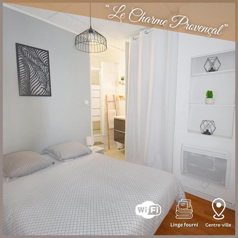 a white bedroom with a bed and a fireplace at Le Charme Provençal - Centre-ville - Calme in Digne-les-Bains
