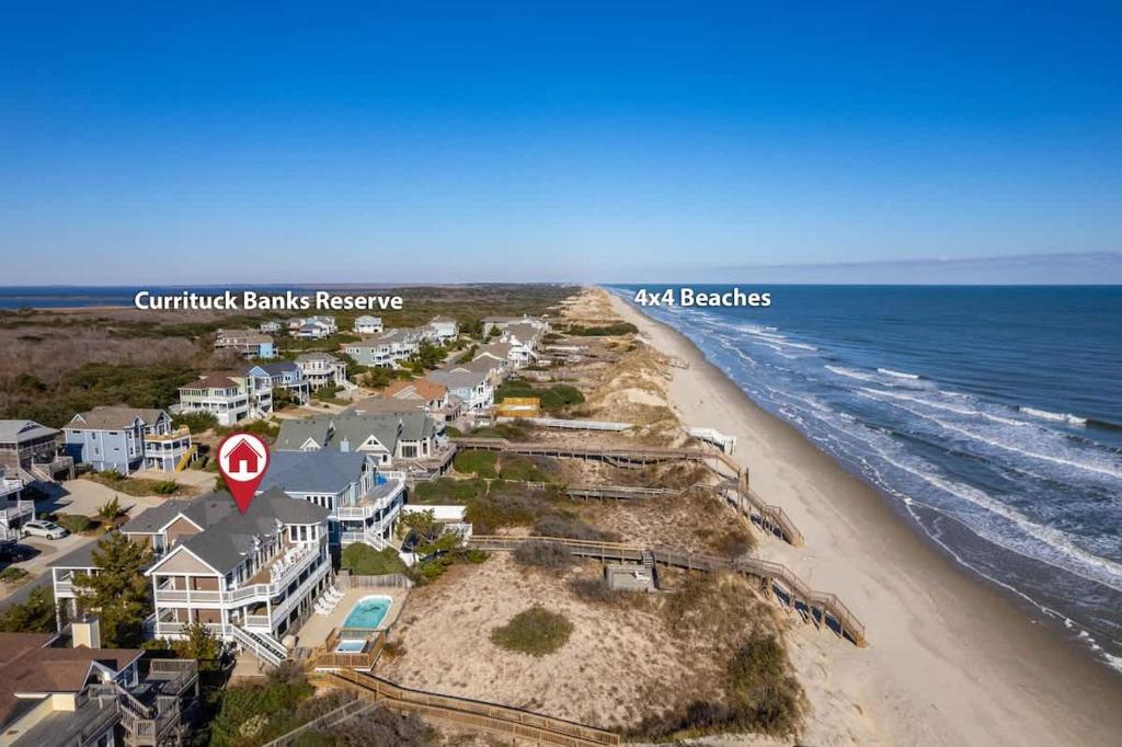 an aerial view of a beach with houses at Beachfront Bliss with Pool & Hot Tub in Corolla