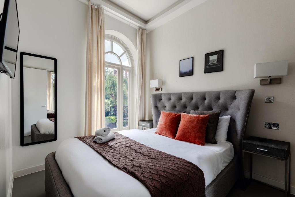 سرير أو أسرّة في غرفة في High Street Kensington Apartments