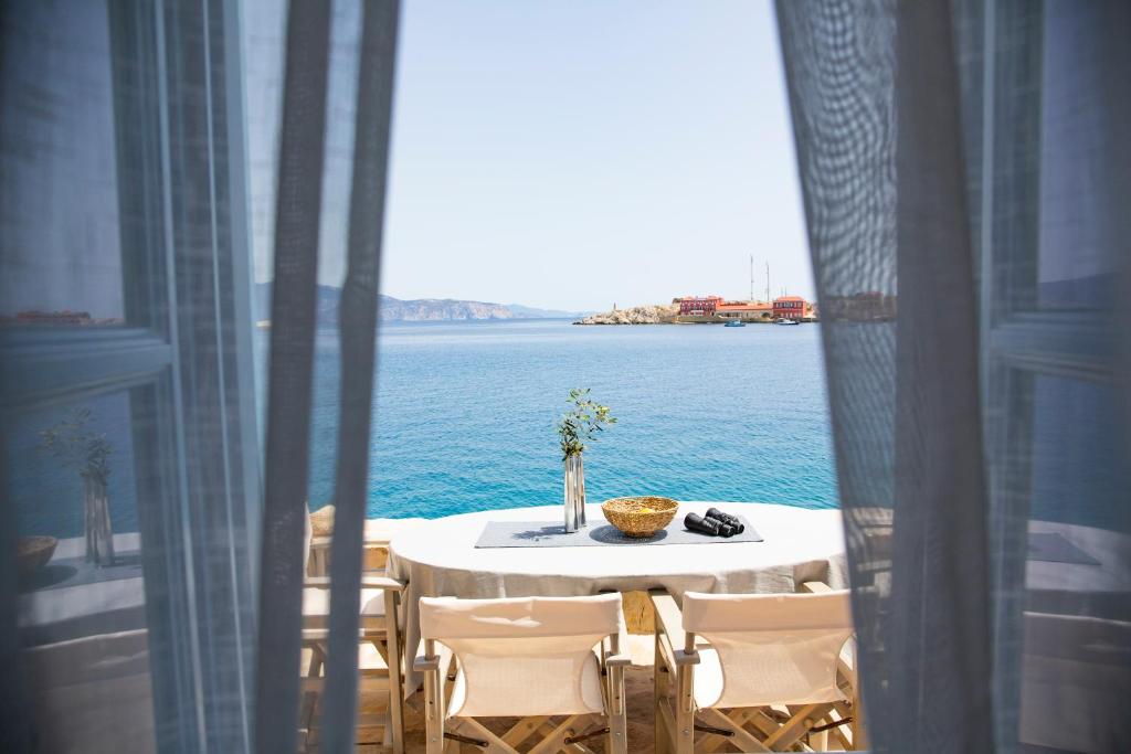 a table and chairs with a view of the water at Villa Annouska in Halki