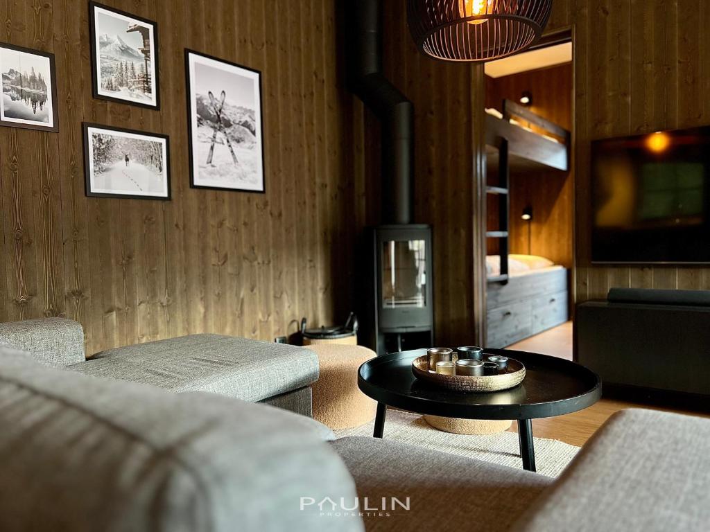 a living room with a couch and a table at Lindvallen Ski Resort Pool and Padel - Sauna - 6 Guests - Pet Friendly in Sälen