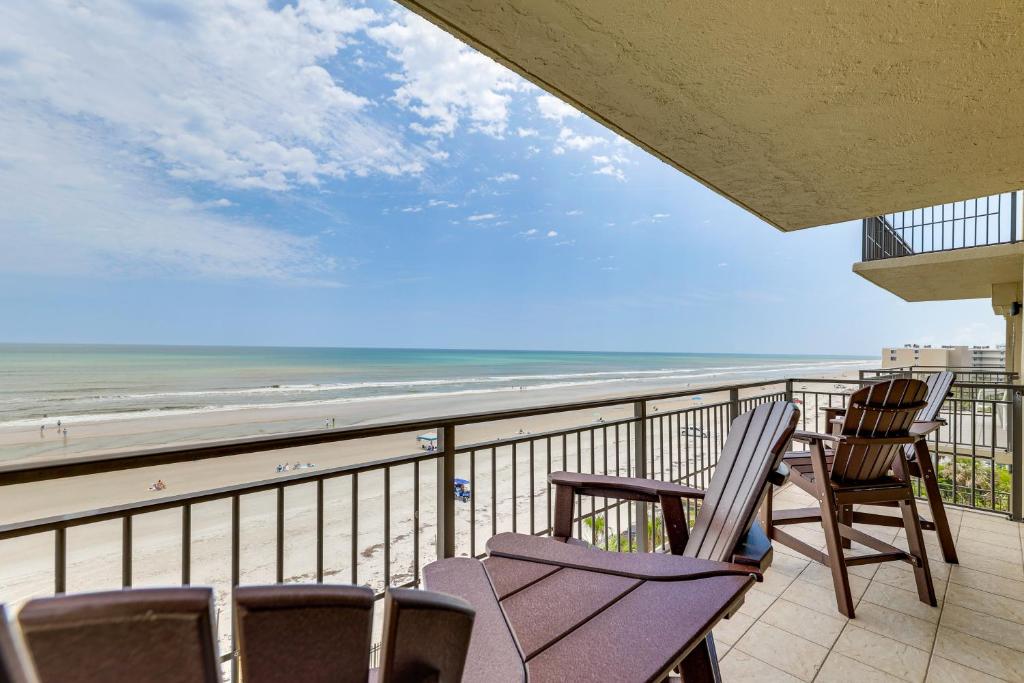 a balcony with chairs and a view of the beach at Beachfront New Smyrna Condo: 1 Mi to Flagler Ave in New Smyrna Beach