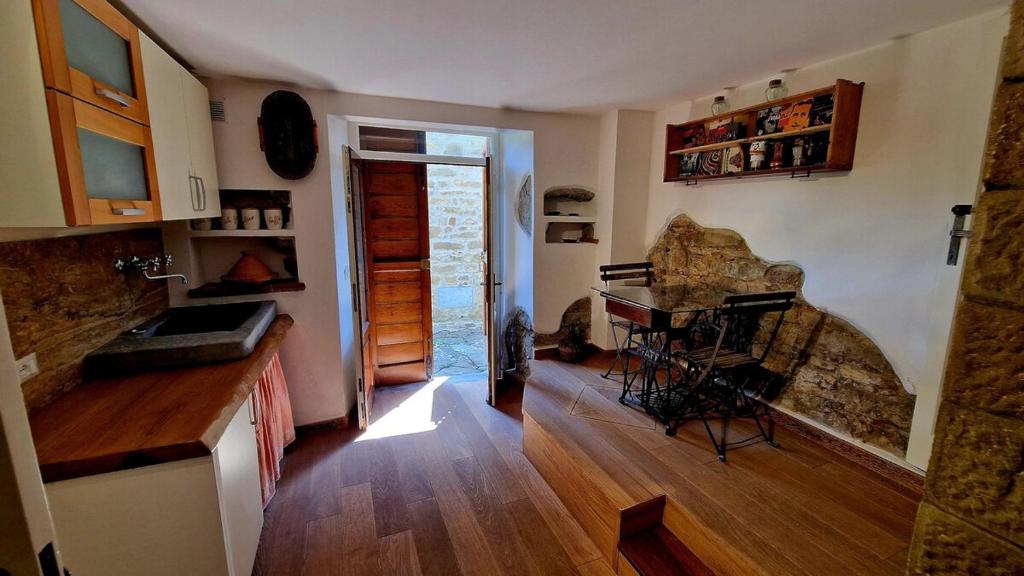 a kitchen with a counter and a table with chairs at Tuscany, Loro Ciuffenna Mountain Bike&walking in San Clemente in Valle