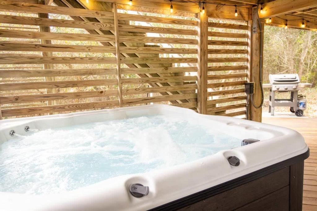 een hot tub in een kamer met een houten muur bij Pool Hot Tub Beach Gear included in Corolla