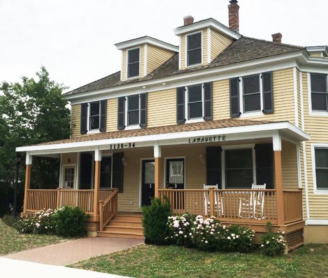 a large house with a large porch with a deck at 1136 And 1138 Lafayette Street Condo in Cape May