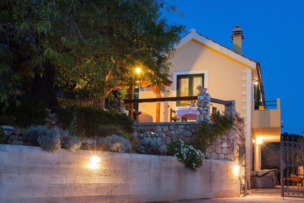 a house with a staircase leading up to it at night at Villa Lora in Tučepi