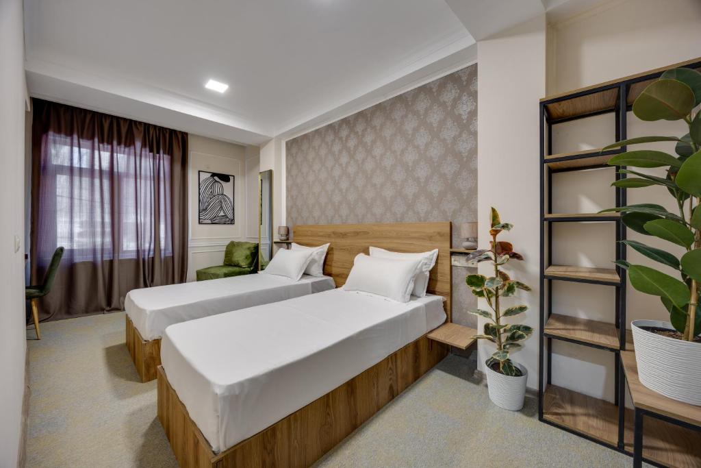 Postel nebo postele na pokoji v ubytování Regraph Hotel