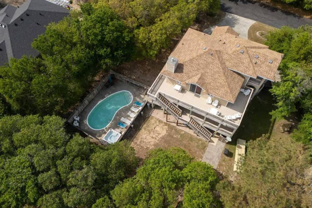 an aerial view of a house with a swimming pool at Stylish Home with Pool Hot Tub & Walk to Beach in Duck