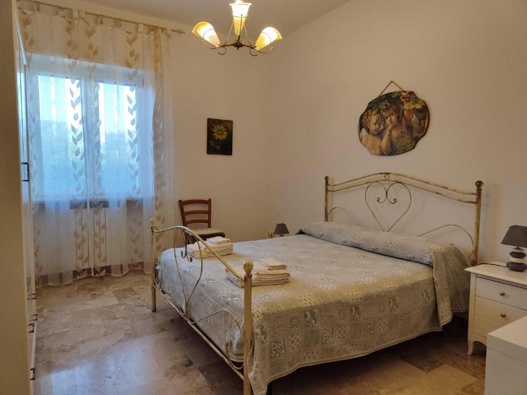 a bedroom with a bed and a clock on the wall at CASA DORI in Cisternino