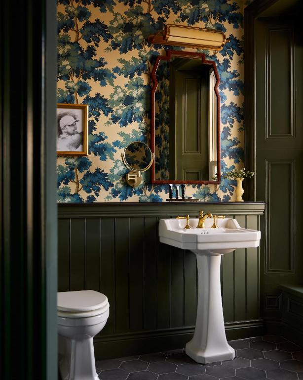 a bathroom with a sink and a mirror at Portrush Adelphi in Portrush