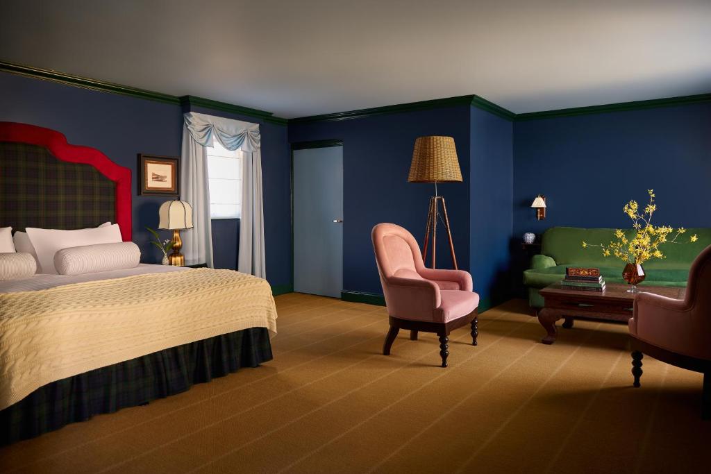 a bedroom with a bed and a chair and a desk at Portrush Adelphi in Portrush