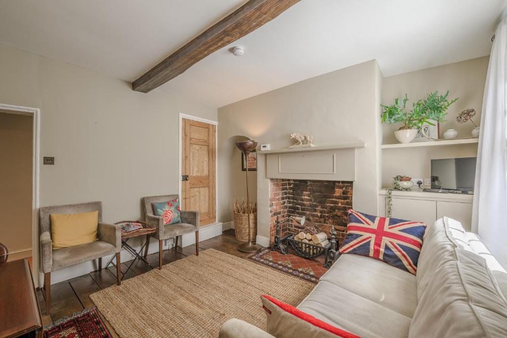 a living room with a couch and a fireplace at St. John’s hill - with parking in Shrewsbury