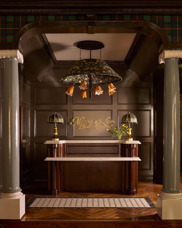 a chandelier hanging from a ceiling in a room at Portrush Adelphi in Portrush