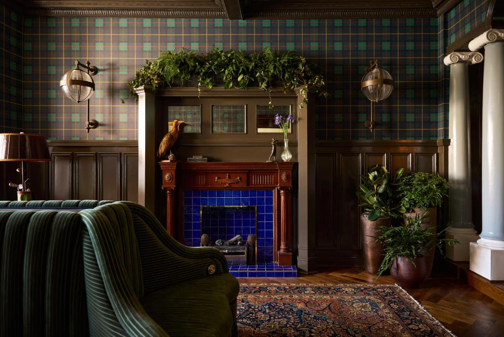 a living room with a fireplace and a couch at Portrush Adelphi in Portrush