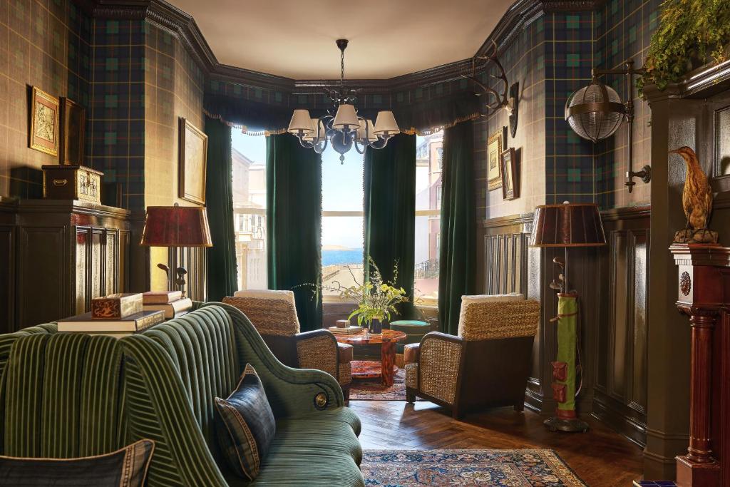 a living room with a couch and chairs and a window at Portrush Adelphi in Portrush