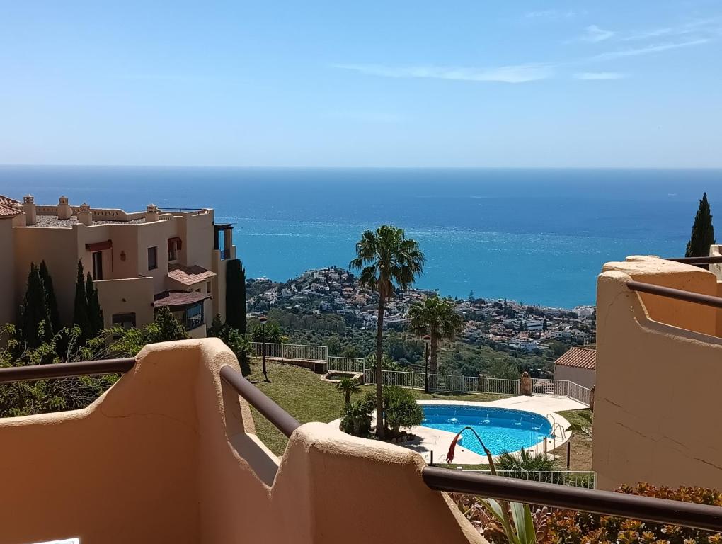 a view from the balcony of a house with a swimming pool at Pilar Luxury Apartment in Benalmádena