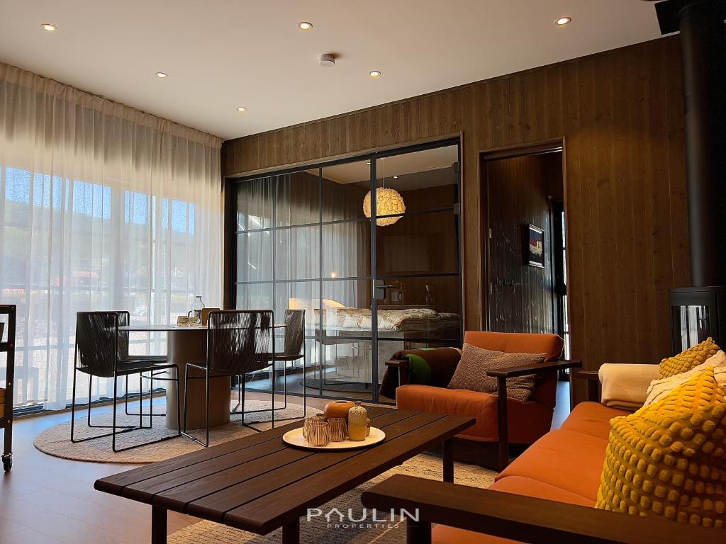 a living room with a couch and a table at Lindvallen Ski Resort Pool and Padel - Sauna - 4 Guests in Herräng