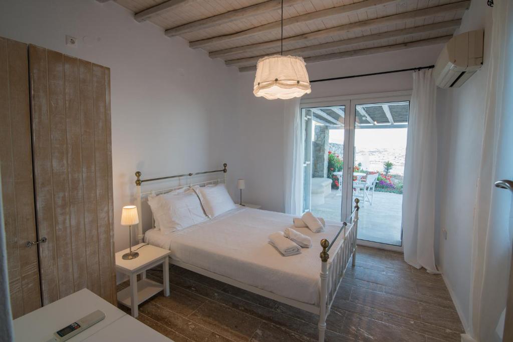 オルノスにあるCorfos Sea Viewの白いベッドルーム(ベッド1台、窓付)