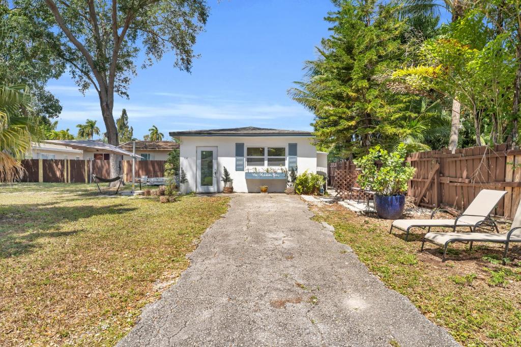 a small white house with a fence at The Hidden Gem - Private Cottage in Biscayne Park in North Miami