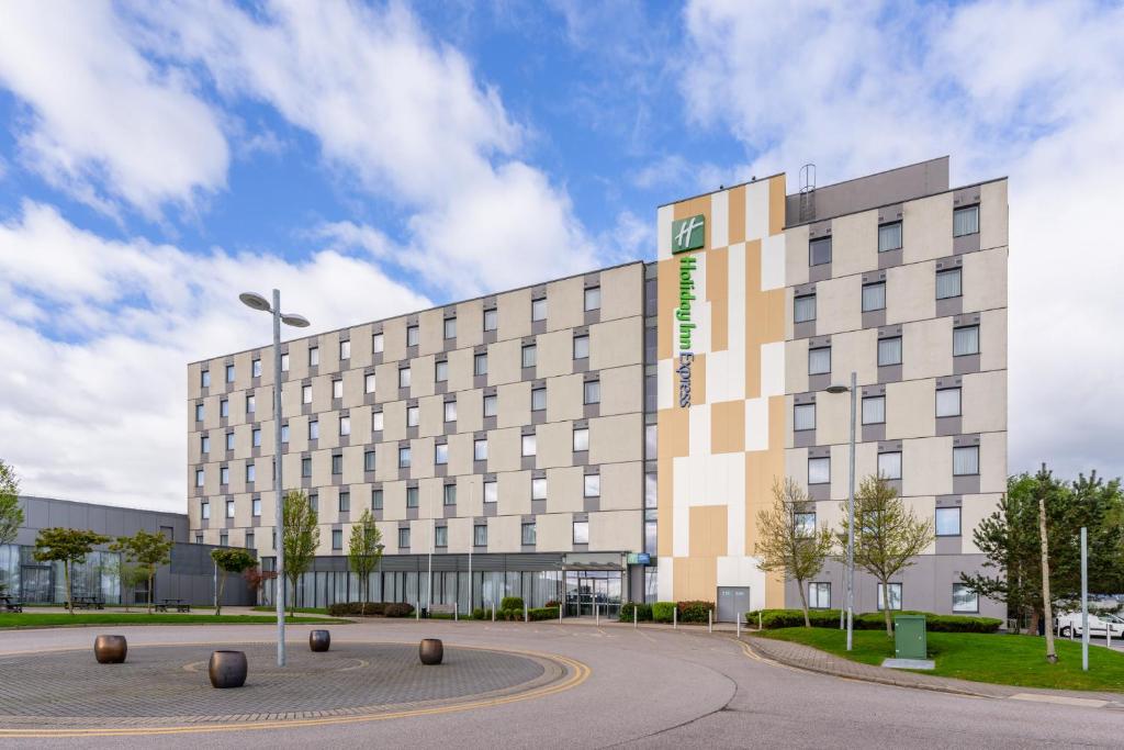 a large building in front of a building at Holiday Inn Express Aberdeen Airport by IHG in Dyce