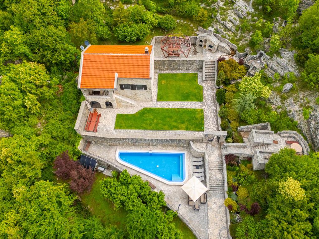 an aerial view of a house with a swimming pool at Blake's Villa in Budva