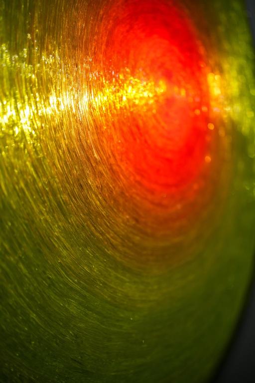 a close up of a green and red object at LΛ DIMӨRΛ di KΛMΛ' in Cesena