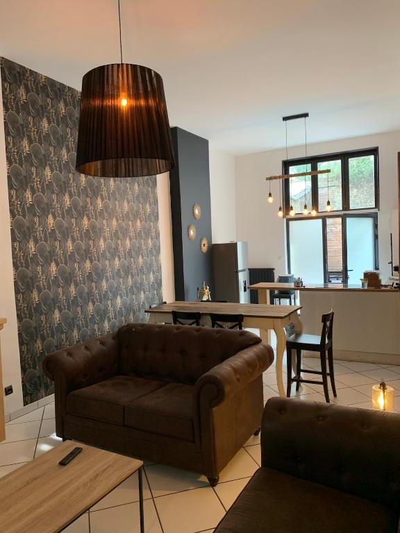 un salon avec un canapé et une table dans l'établissement Maison atypique au pied de l'Eglise St Géry, à Cambrai