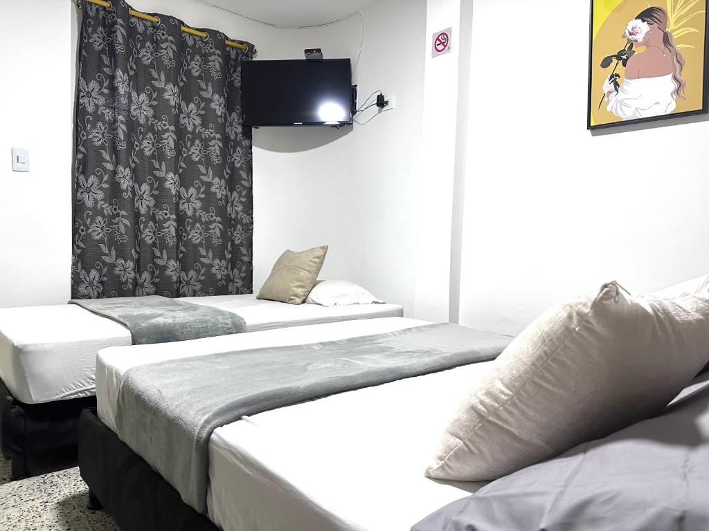 Postel nebo postele na pokoji v ubytování Hotel Guayacanes 70