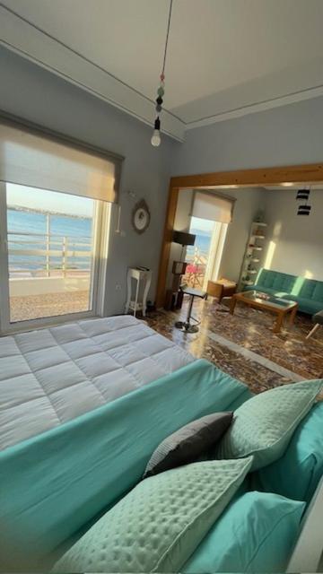 a bedroom with two beds and a view of the beach at appartment view sea artemida 2 in Artemida