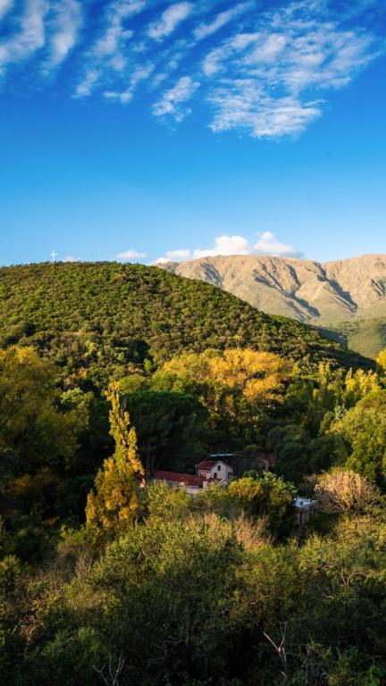 a house on a hill with mountains in the background at Hotel Loma Bola in La Paz