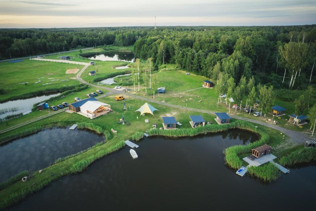 an aerial view of a campgrounds on an island in the water at Tūjas dīķi in Tūja