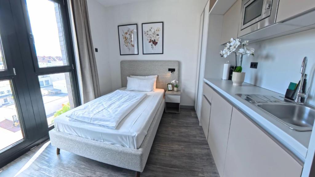 Postel nebo postele na pokoji v ubytování NOVERA Aparthotel