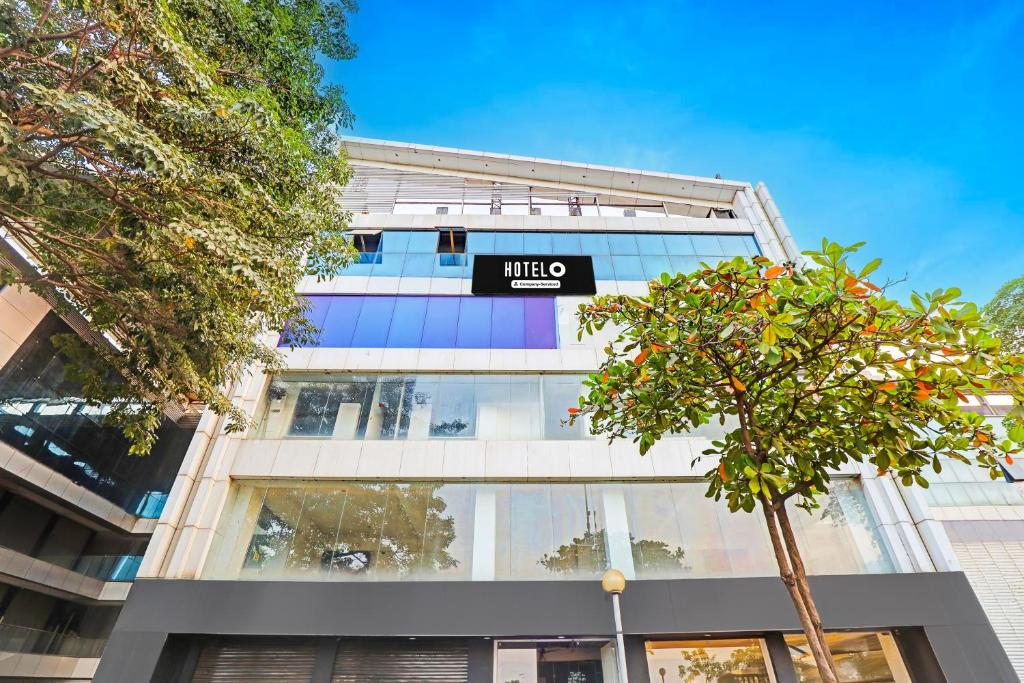 a building with a sign that reads mico at Hotel O Althan Formerly Hotel Niraant in Surat