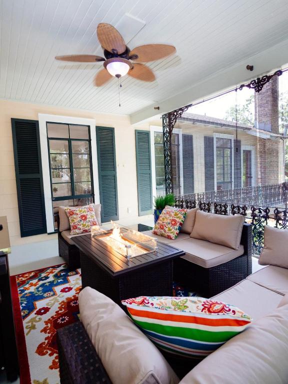 a living room with couches and a ceiling fan at The Nest in Mobile