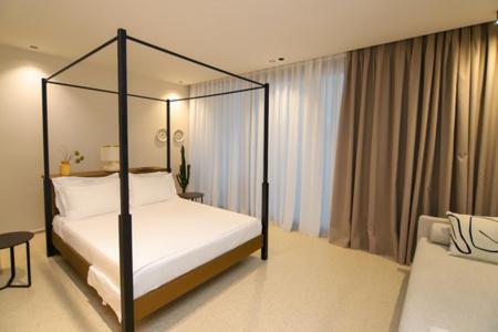 Postel nebo postele na pokoji v ubytování Hotel Olympia Touristic Village