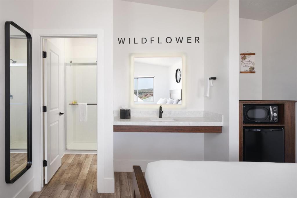 a white bathroom with a sink and a mirror at Zion Wildflower Resort in Virgin