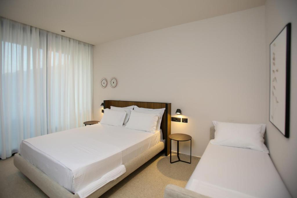 Postel nebo postele na pokoji v ubytování Hotel Olympia Touristic Village
