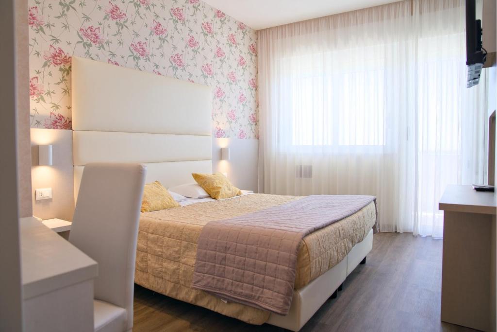 Postel nebo postele na pokoji v ubytování Hotel Benini