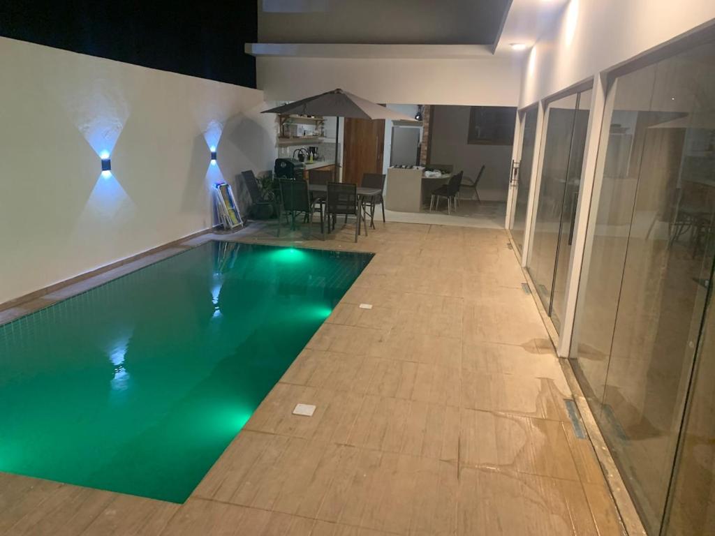 a swimming pool in the middle of a room at Sunset Patacho in Pôrto de Pedras