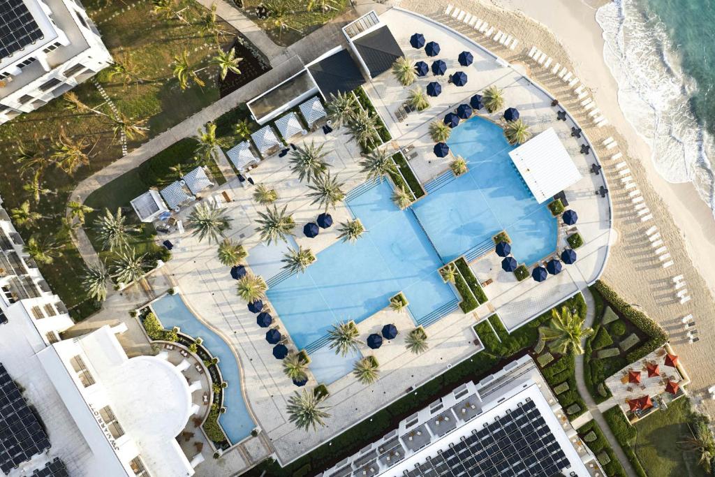 an overhead view of a swimming pool next to a beach at JW Marriott St Maarten Beach Resort & Spa in Dawn Beach