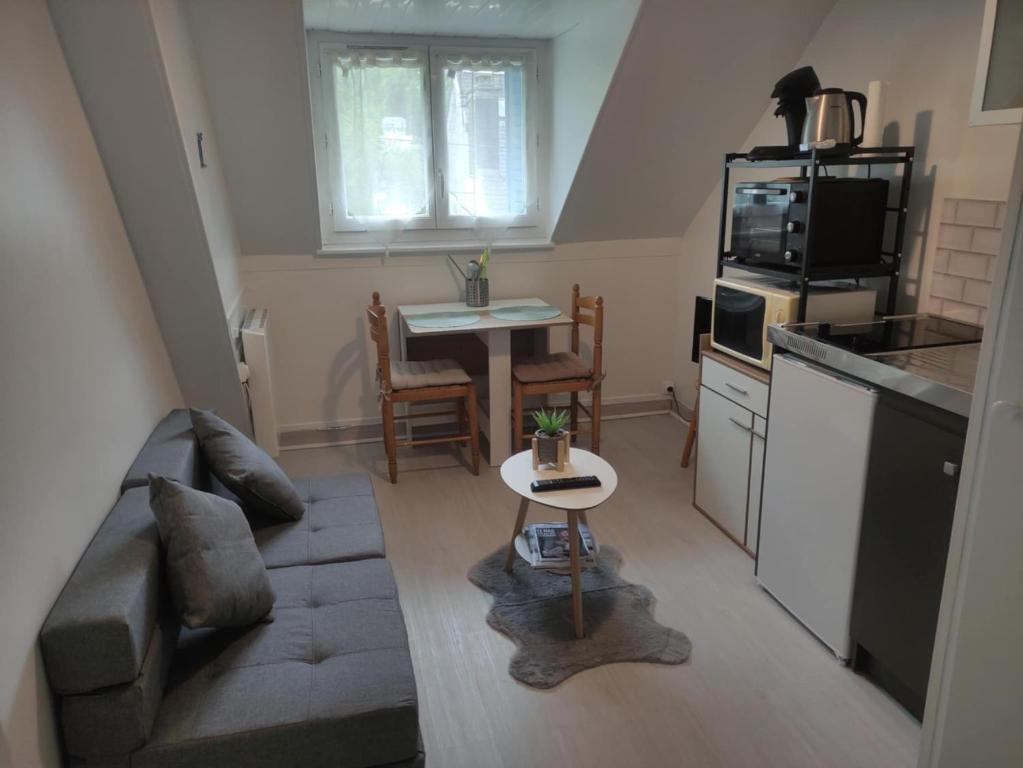 un petit salon avec un canapé et une table dans l'établissement Villa Lumière, à La Bourboule