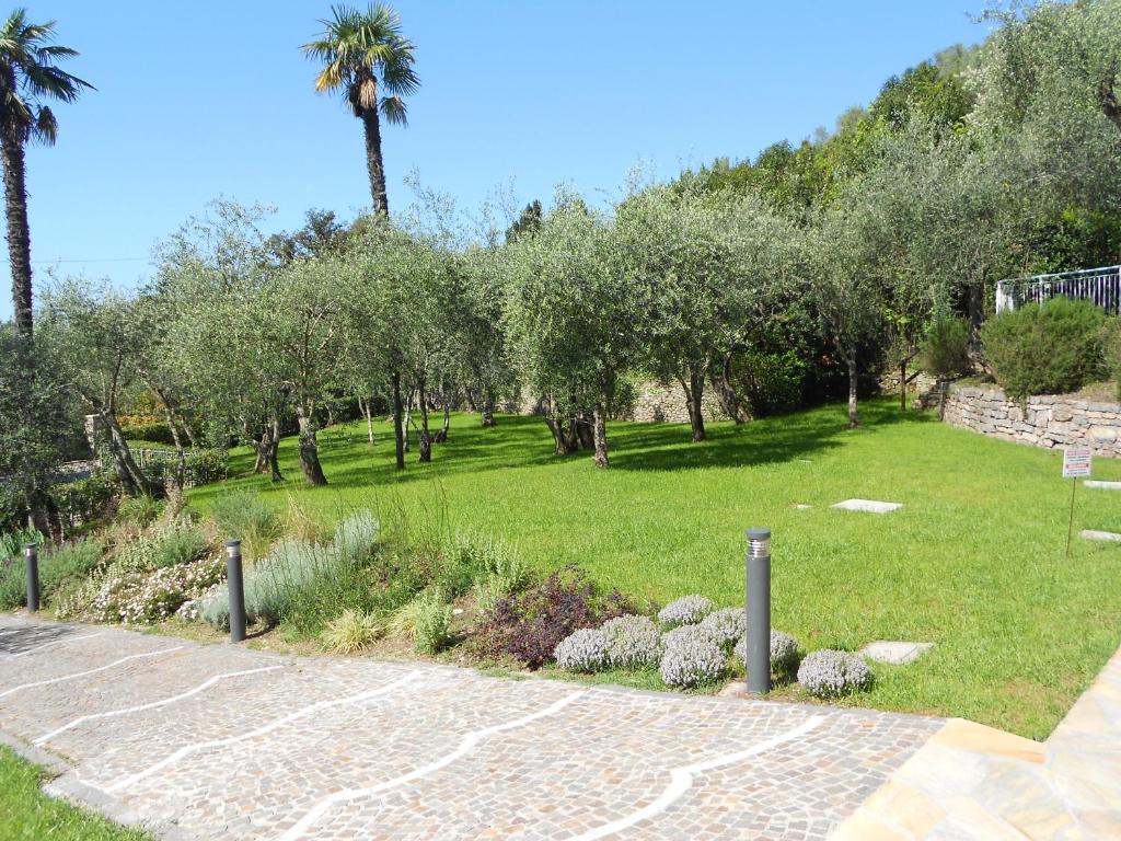 a park with trees and grass and a path at Albergo Blueline in Tellaro