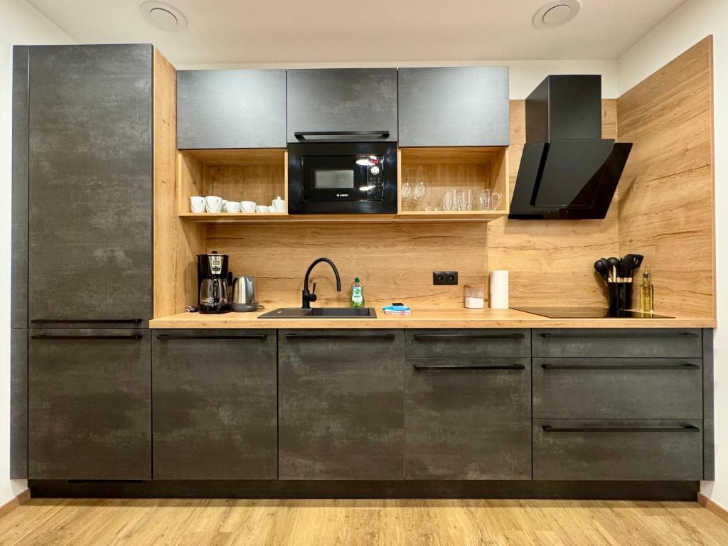 Kuchyň nebo kuchyňský kout v ubytování Apartmány nora