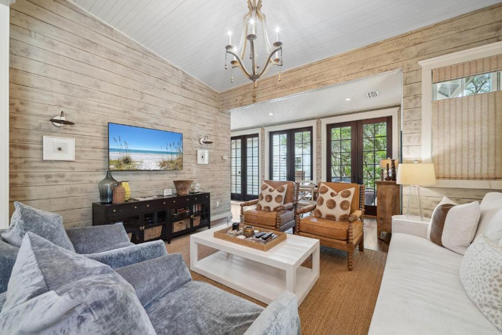 a living room with a couch and a table at 67 Wiggle Lane - Rosemary Beach - Steps to Tennis Courts, Beach, Pools! in Rosemary Beach