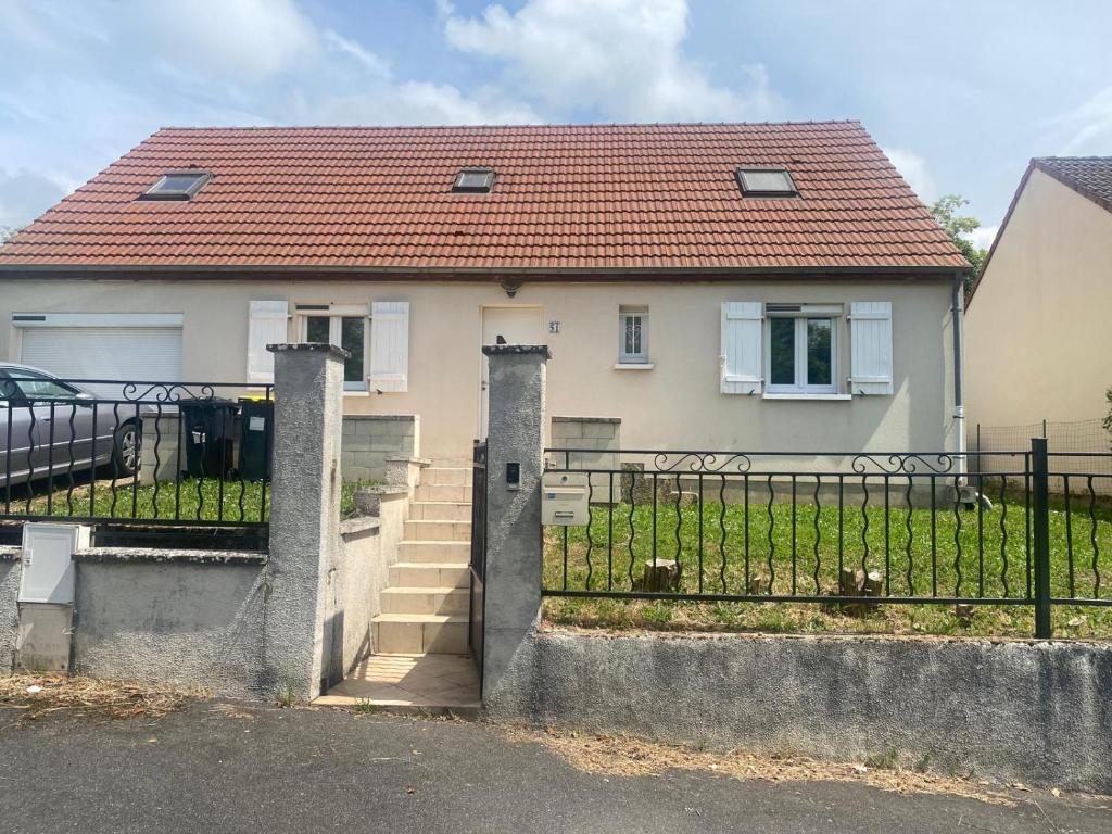 a house with a gate in front of it at Maison familiale - Jardin - Parking - Wifi in Pithiviers