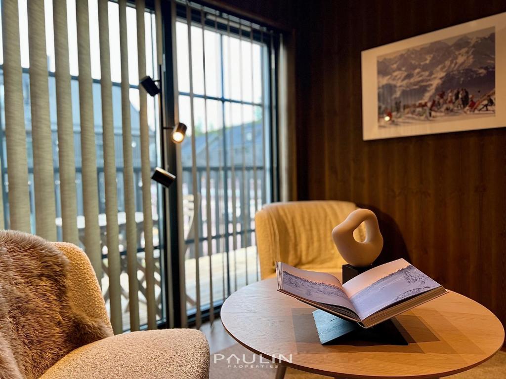 a room with a table with a book and a chair at Lindvallen Ski Resort Pool and Padel - Sauna - 4 Guests in Sälen