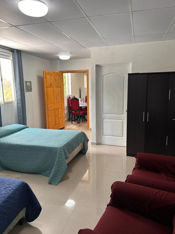 a bedroom with two beds and a desk in it at Country House in Los Planes VACATION RENTAL in Panchimalco