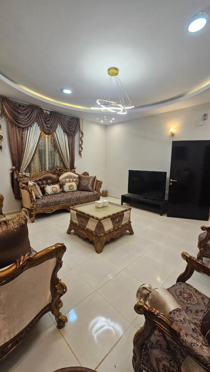 a living room with furniture and a flat screen tv at شقق سكنية مفروشة بالباحة 1 in Al Jith