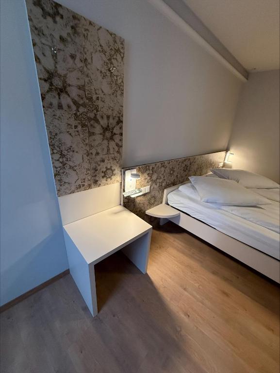 a bedroom with a bed and two tables in it at Pension Villa Colosseo im Herzen von Meiningen in Meiningen